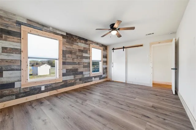 a living room with furniture a ceiling fan and a window