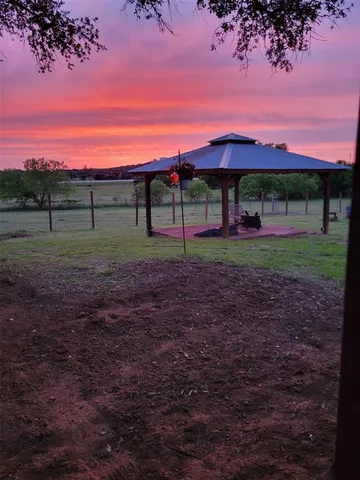 a view of a swimming pool with a yard