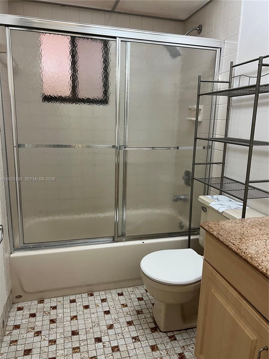 8400 Southwest 133rd Avenue Road, Unit 121 Miami, FL 33183 - Photo 38 of 43 a bathroom with a granite countertop sink toilet and shower