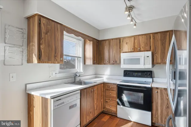 a kitchen with a stove sink and microwave