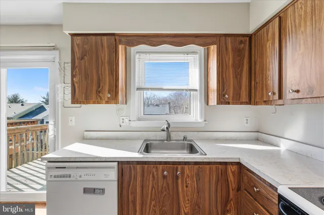 a kitchen with a sink cabinets and window