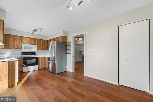 a kitchen with stainless steel appliances a refrigerator and a stove top oven