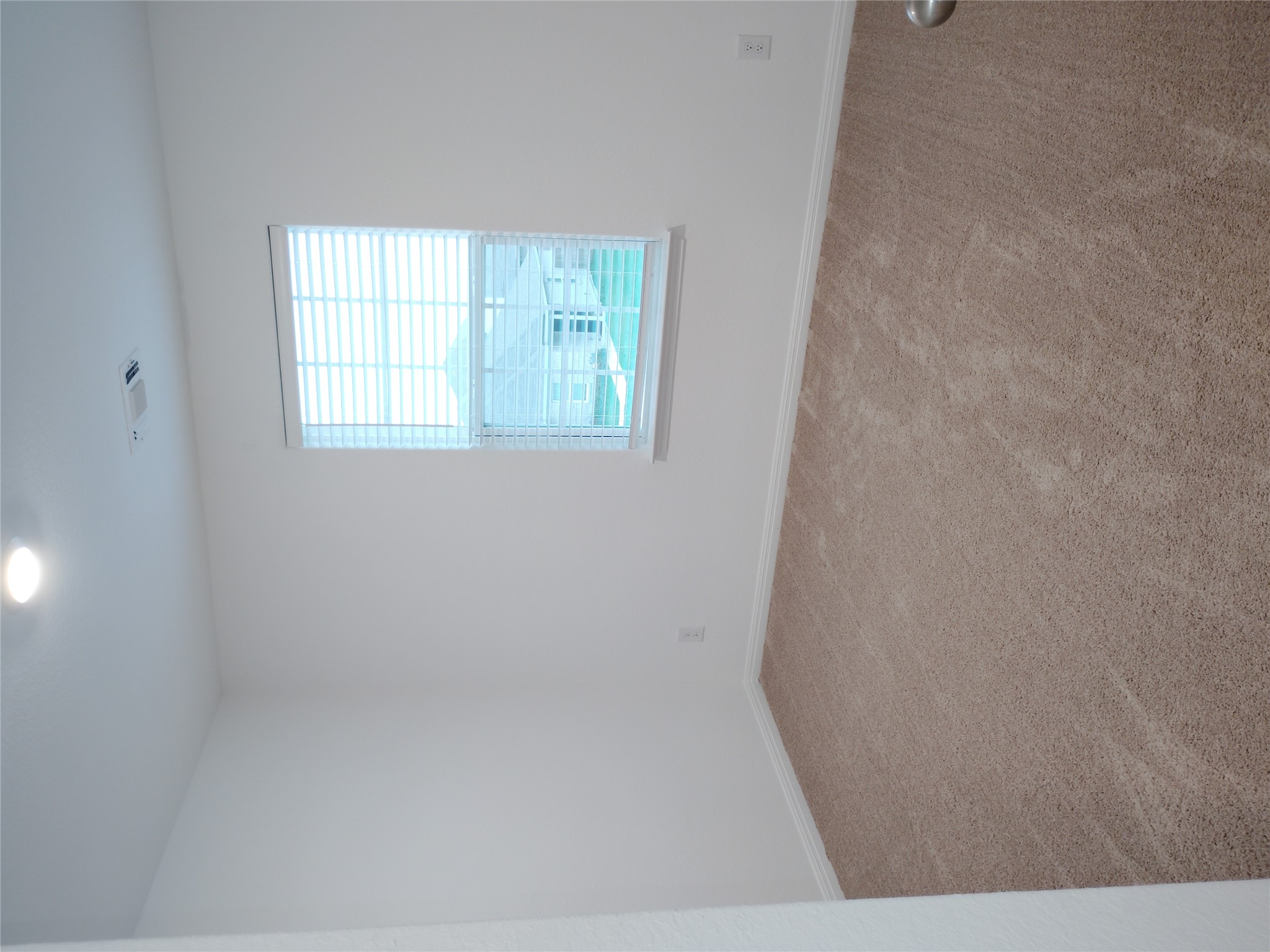 14024 Prairie Schooner Pass Elgin, TX 78621 - Photo 16 of 20 Neutral-toned carpeting paired with white walls, a single window with blinds, and a recessed ceiling light fixture