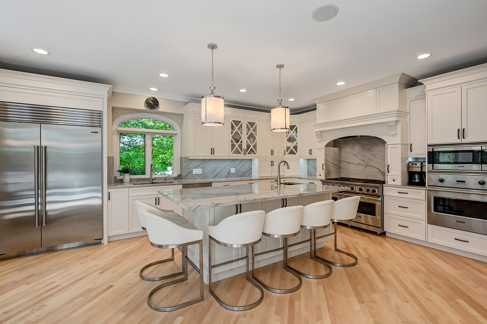 9301 Falling Waters Drive East Burr Ridge, IL 60527 - Photo 14 of 52 a kitchen with stainless steel appliances kitchen island granite countertop a stove a sink a refrigerator and chairs