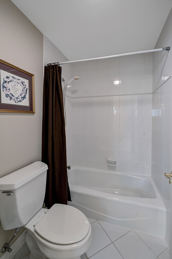 9301 Falling Waters Drive East Burr Ridge, IL 60527 - Photo 29 of 52 a white toilet and tub sitting next to a bathroom sink