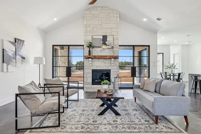 a living room with furniture and a fireplace
