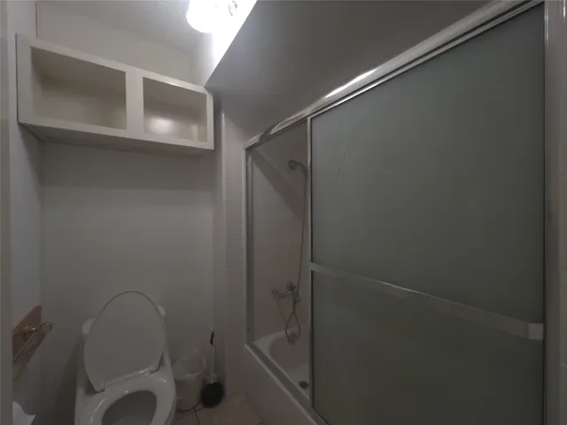 a bathroom with a shower and a toilet
