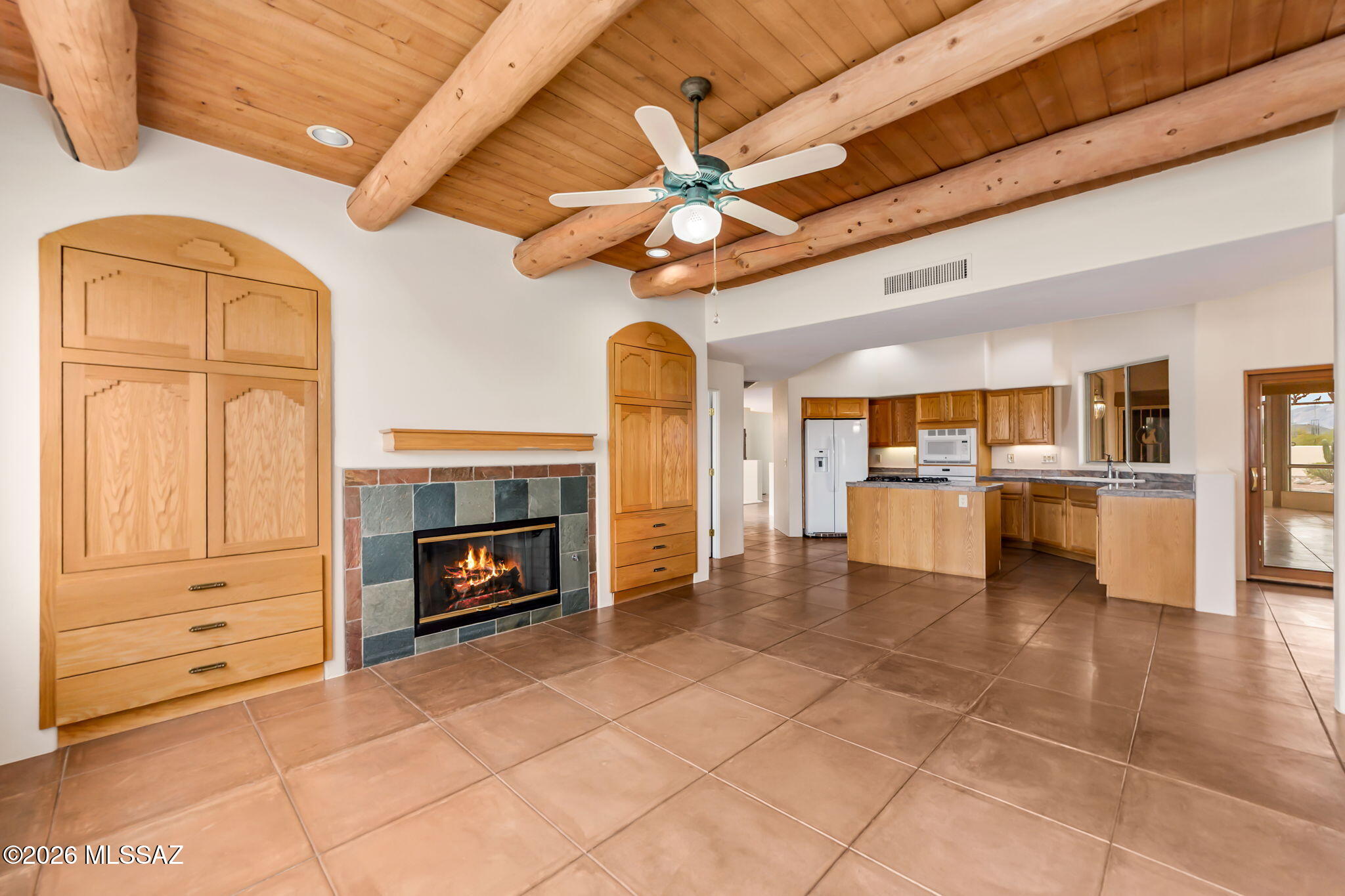3655 North Harrison Road Tucson, AZ 85749 - Photo 22 of 51 a view of an empty room with a fireplace and a chandelier fan