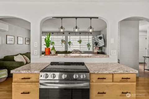 a stove top oven sitting inside of a kitchen