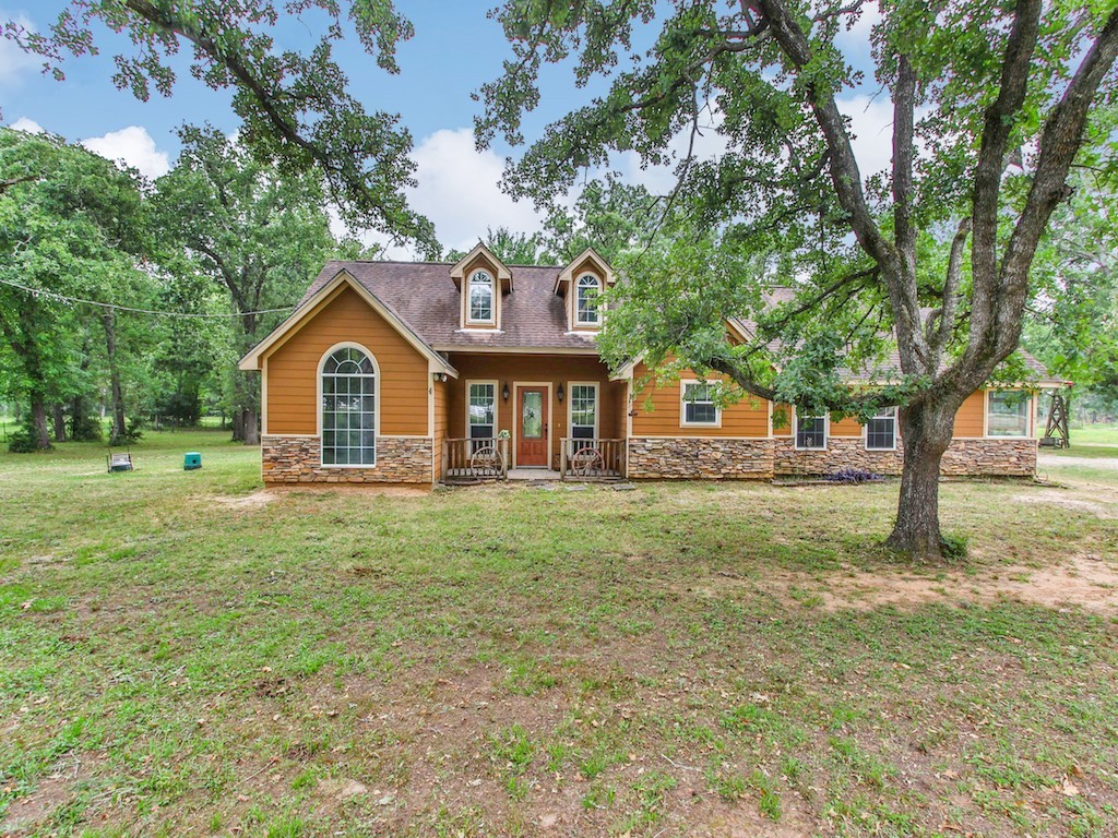 New england style home with covered porch and a fr