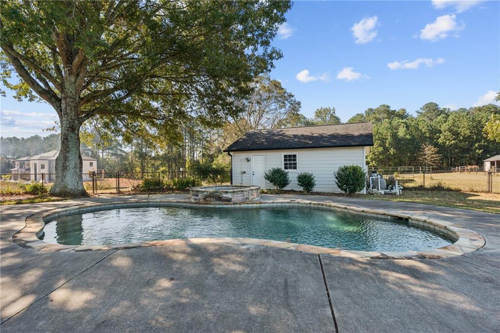 2740 Talley Lane Buford, GA 30519 - Photo 11 of 16 a view of swimming pool with outdoor seating and a garden