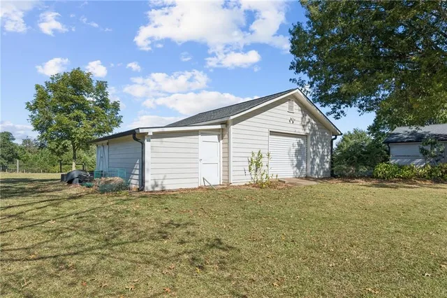 a view of a house with a yard and sitting area