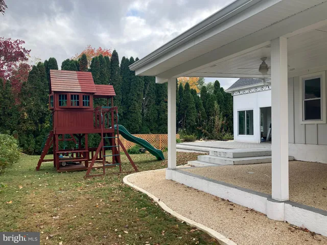 a view of a house with backyard porch and sitting area