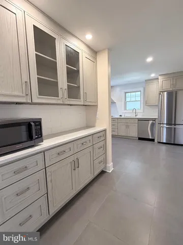a kitchen with cabinets and window
