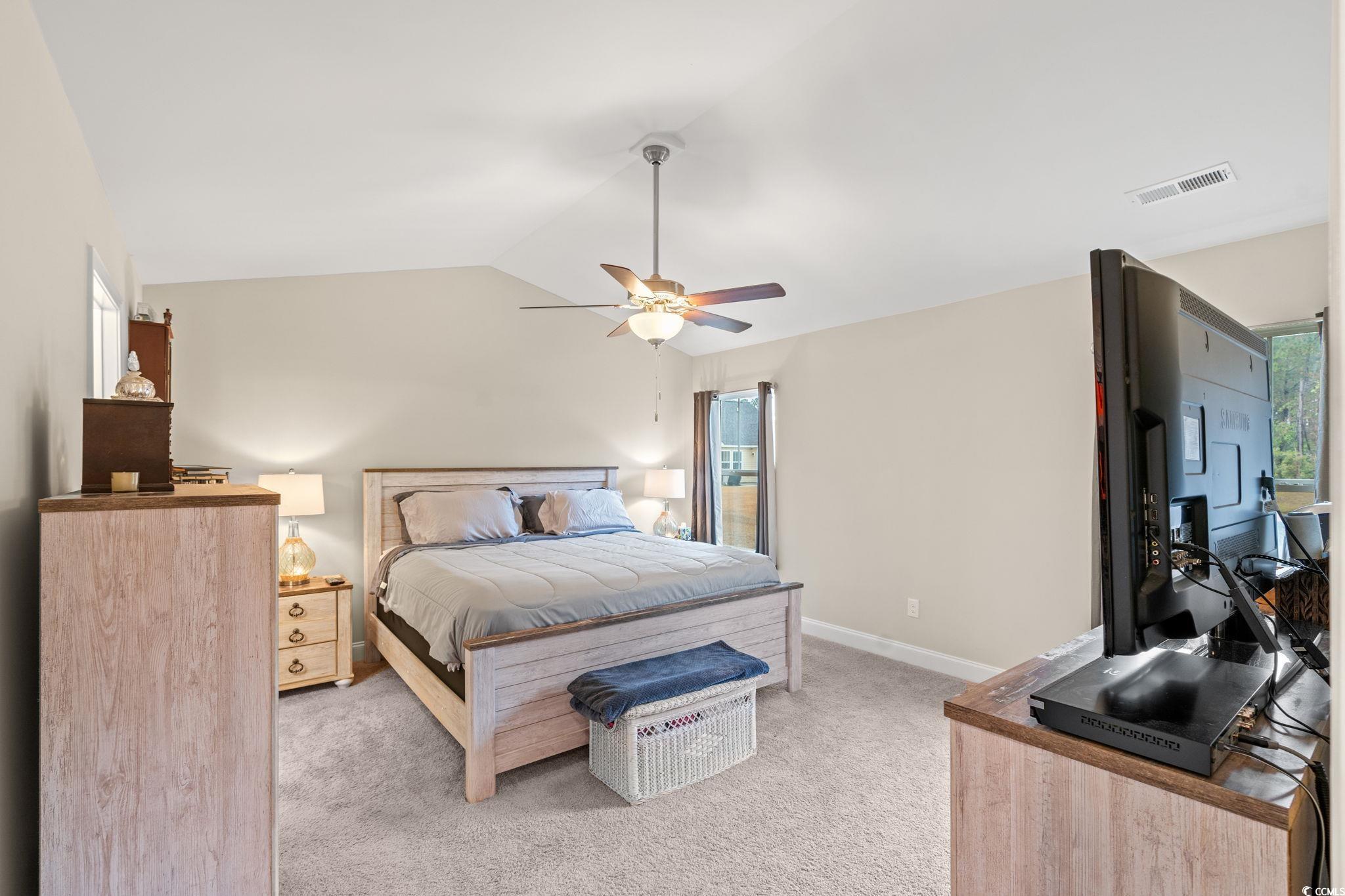 1209 Wehler Court Conway, SC 29526 - Photo 13 of 32 Bedroom with multiple windows, light colored carpet, lofted ceiling, and a ceiling fan