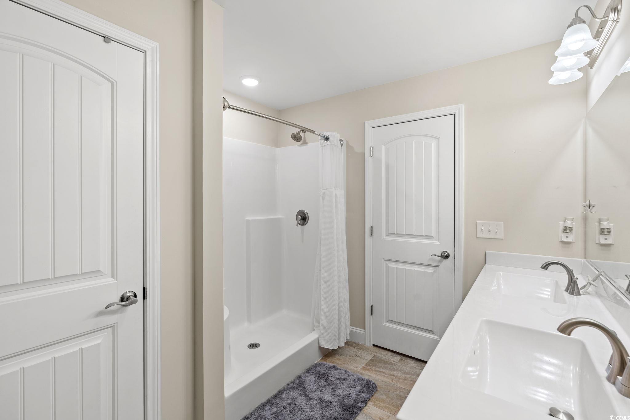 1209 Wehler Court Conway, SC 29526 - Photo 15 of 32 Bathroom with a stall shower and double vanity