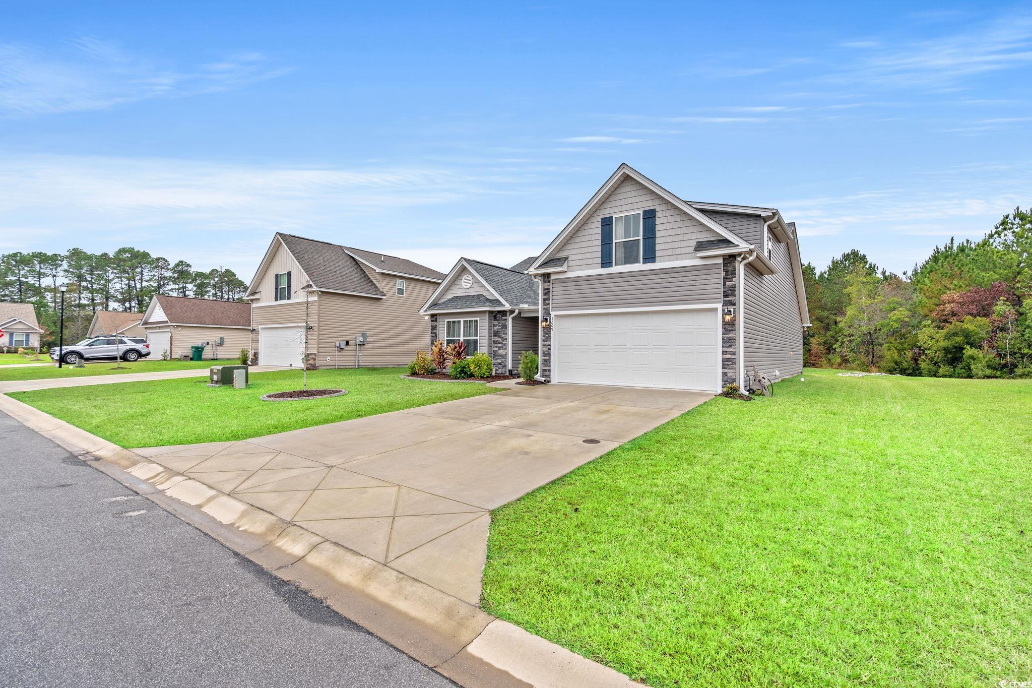 1209 Wehler Court Conway, SC 29526 - Photo 2 of 32 Traditional-style home with stone siding, a garage, concrete driveway, and a front yard
