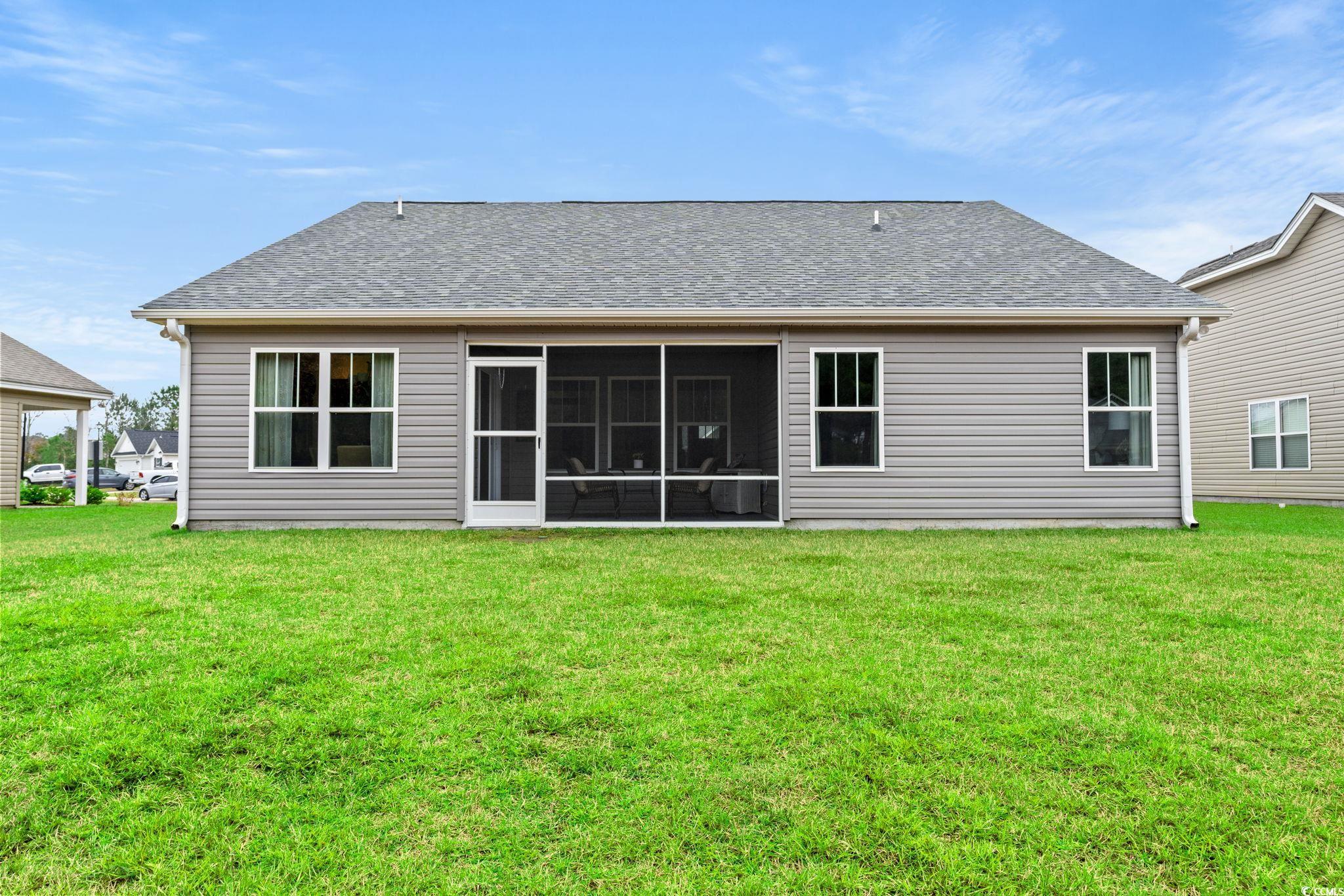 1209 Wehler Court Conway, SC 29526 - Photo 26 of 32 Back of property with a lawn, roof with shingles, and a sunroom