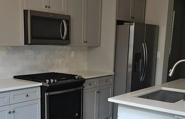 a kitchen with a stove microwave and refrigerator