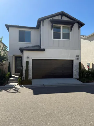 a living room with a fireplace a flat screen tv and a fireplace