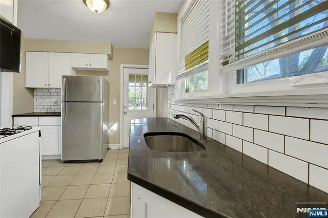 a kitchen with a sink and a refrigerator