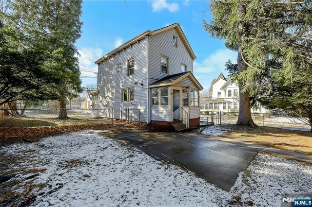 a view of a town with large trees and a barn