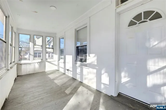 a large white room with a large window and flat screen tv