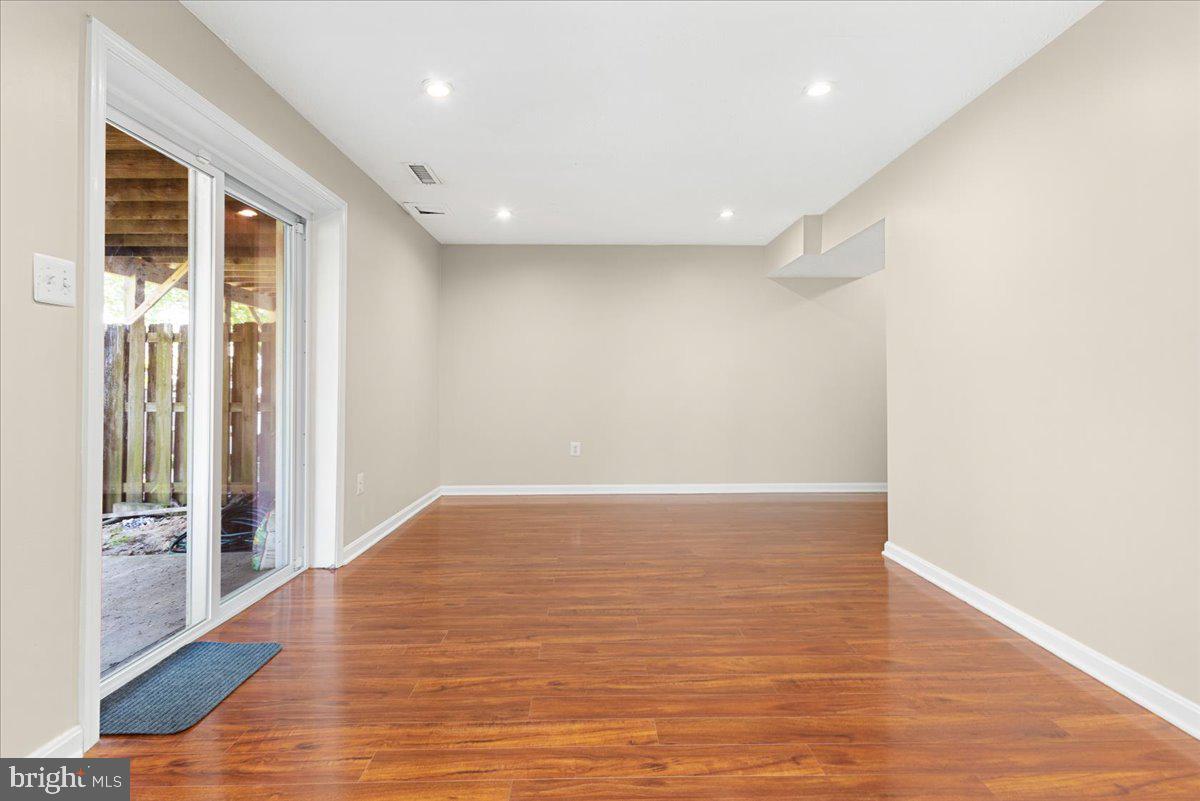 316 Rambling Ridge Court Pasadena, MD 21122 - Photo 19 of 26 Lower Level Family Rm with Slider to Covered Patio