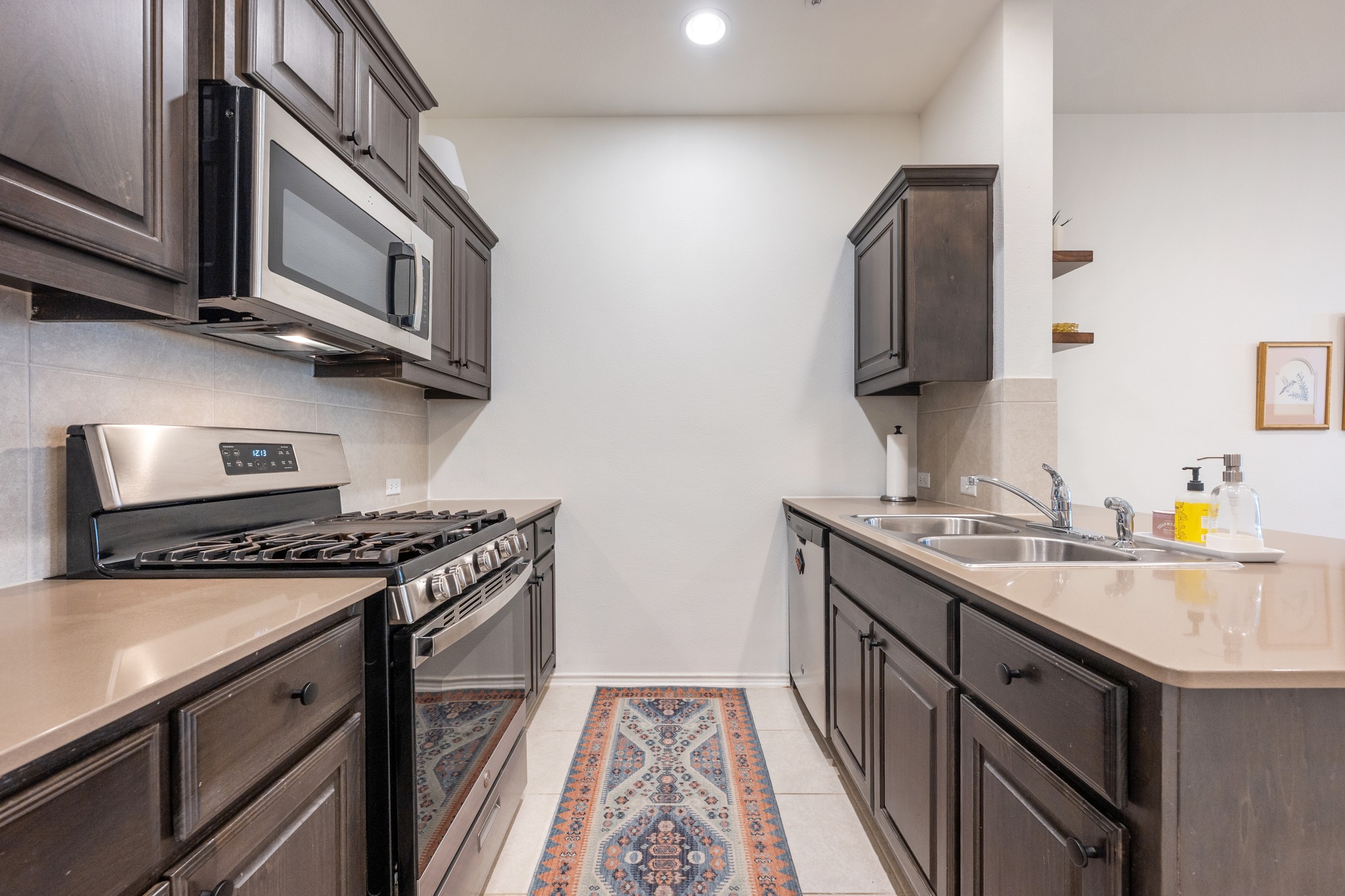 4400 Vaughan Street, Unit B Austin, TX 78723 - Photo 12 of 29 a kitchen with stainless steel appliances granite countertop a stove and a sink