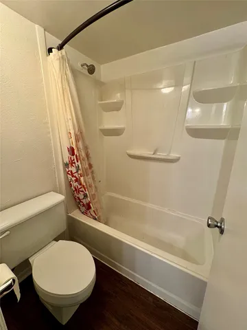 a bathroom with a toilet and a shower