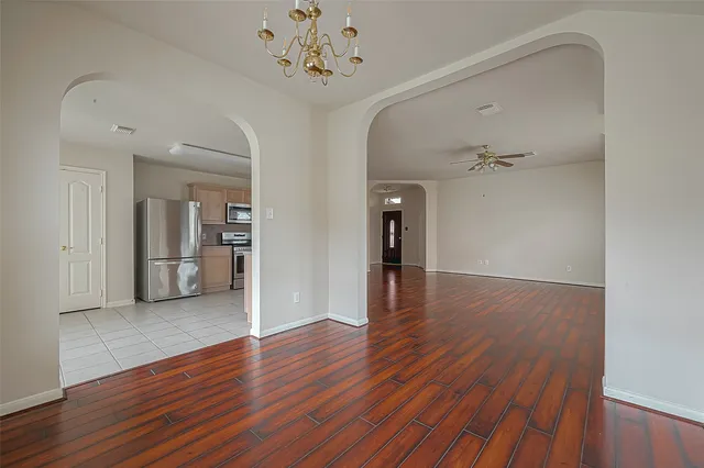 a kitchen with a refrigerator sink and cabinets