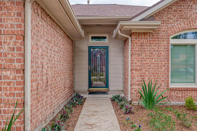 a view of a pathway of the house with potted plants