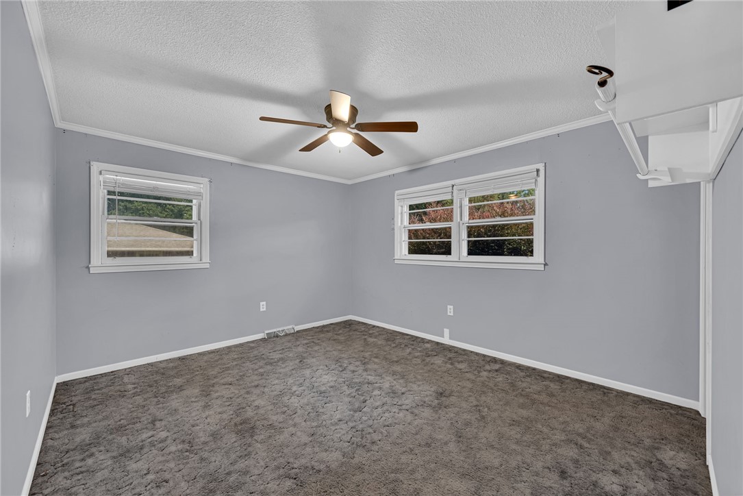 121 Wilson Road Anderson, SC 29625 - Photo 26 of 40 Plush carpeting anchors this versatile room detailed with classic crown molding.