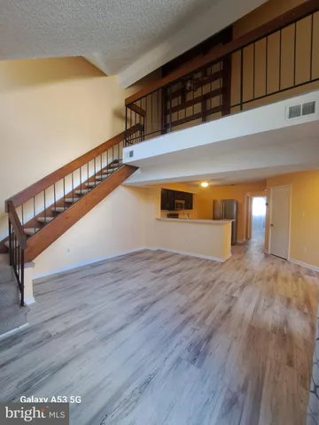 a kitchen with stainless steel appliances a refrigerator a stove a sink and a microwave