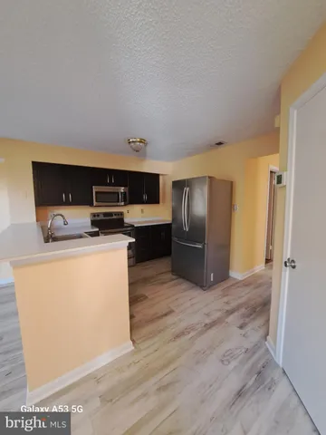 a bedroom with a bed and a night stand