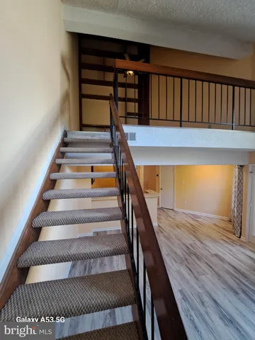 a view of an empty room and wooden floor
