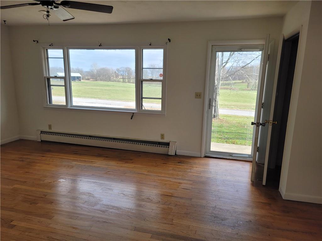 877 North 950 East Road Tower Hill, IL 62571 - Photo 6 of 28 a view of an empty room with wooden floor and a window