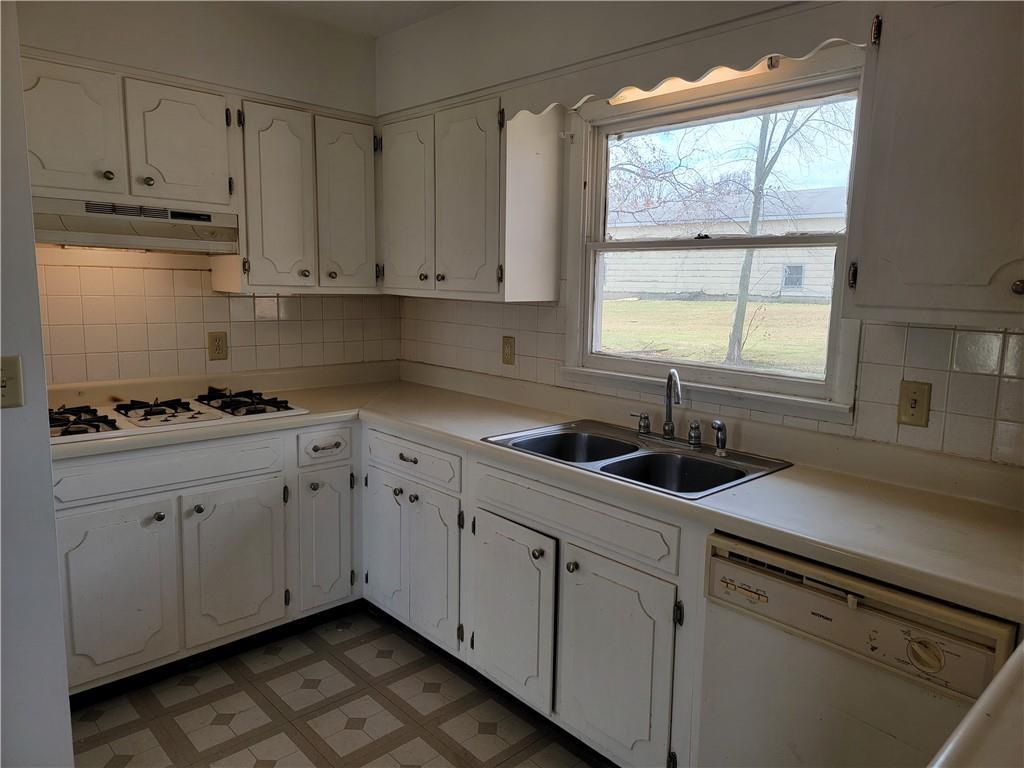 877 North 950 East Road Tower Hill, IL 62571 - Photo 8 of 28 a kitchen with stainless steel appliances granite countertop white cabinets sink and window