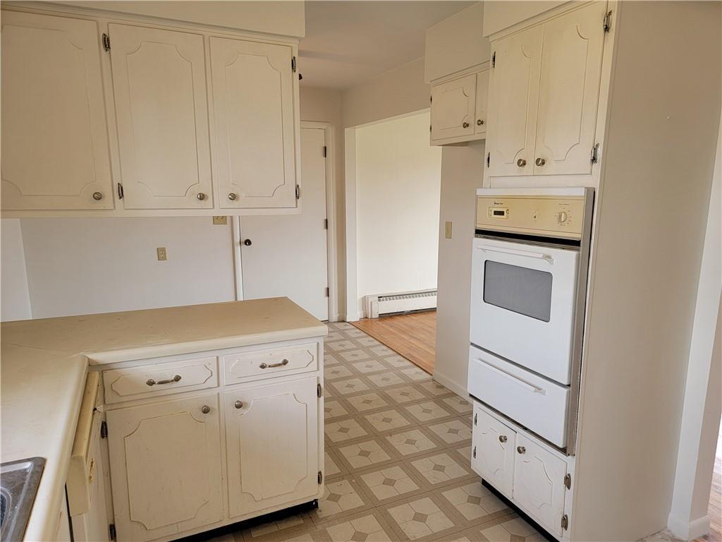 877 North 950 East Road Tower Hill, IL 62571 - Photo 9 of 28 a kitchen with white cabinets and white appliances