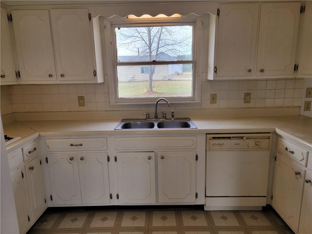 877 North 950 East Road Tower Hill, IL 62571 - Photo 10 of 28 a kitchen with white cabinets and white appliances