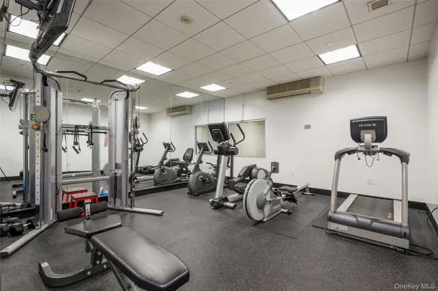 a room with gym equipment and mirror