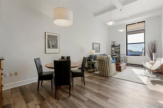 a view of a dining room with furniture window and wooden floor