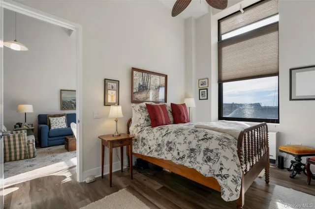 a bedroom with a bed and dresser with mirror