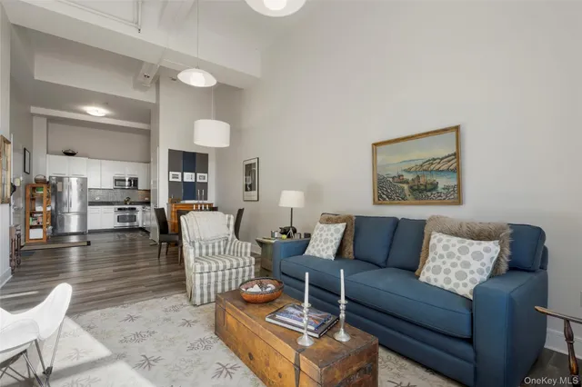 a living room with furniture a rug and a lamp