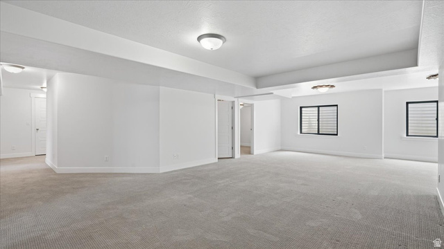 2038 East Ranch Road Eagle Mountain, UT 84005 - Photo 36 of 66 Spacious room featuring light-colored carpet, white walls, and multiple windows with horizontal blinds