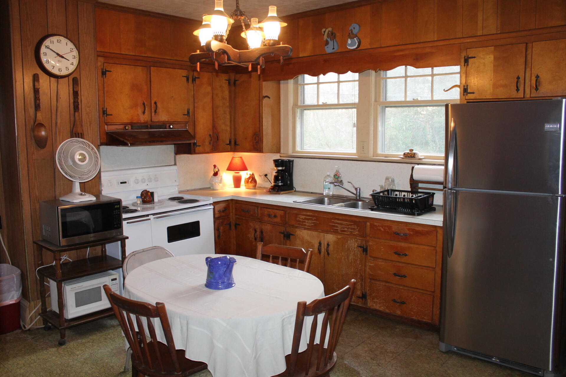 1213 Narrow Passage Road Buchanan, VA 24066 - Photo 2 of 21 a kitchen with a sink a stove a dining table and chairs