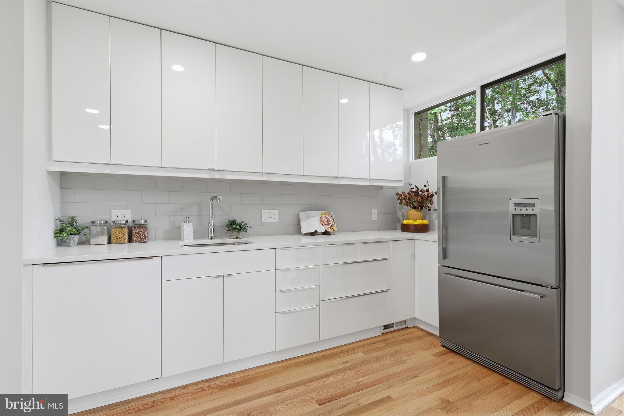 11510 Maple Ridge Road Reston, VA 20190 - Photo 17 of 43 a white refrigerator freezer sitting inside of a kitchen