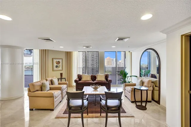 a living room with lots of furniture hardwood floor and a large window