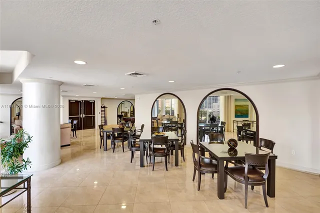 a view of a dining room with furniture and chandelier