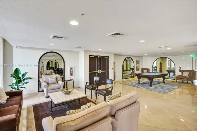 a view of a livingroom with furniture wooden floor and a floor to ceiling window